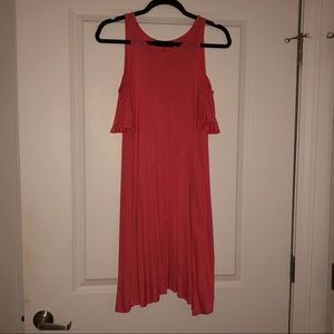 A coral, open-shoulder loose-fit cotton dress